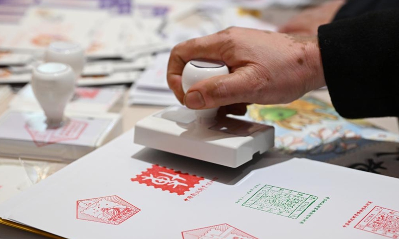 A visitor collects cultural postmarks at China 2024 Asian International Stamp Exhibition in Shanghai Exhibition Center, east China's Shanghai, Nov. 29, 2024. The exhibition opened on Friday and will last for 5 days. (Photo: Xinhua)