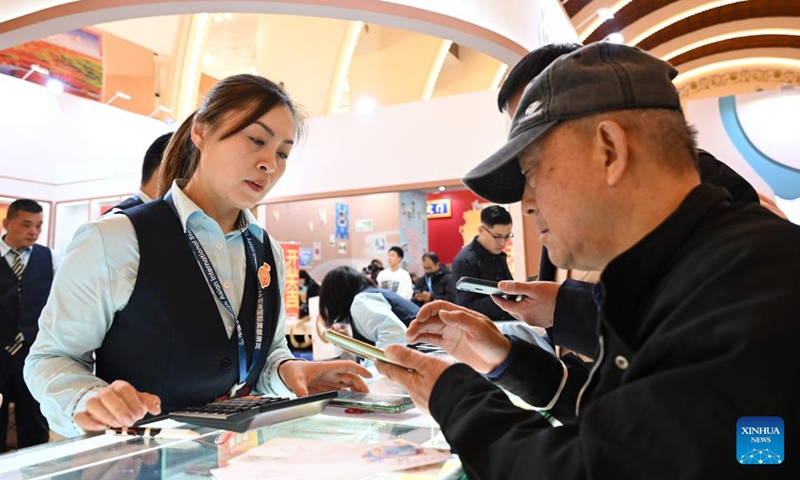 Visitors select stamps at China 2024 Asian International Stamp Exhibition at Shanghai Exhibition Center in east China's Shanghai on Nov. 29, 2024. The exhibition opened on Friday and will last for 5 days. (Photo: Xinhua)