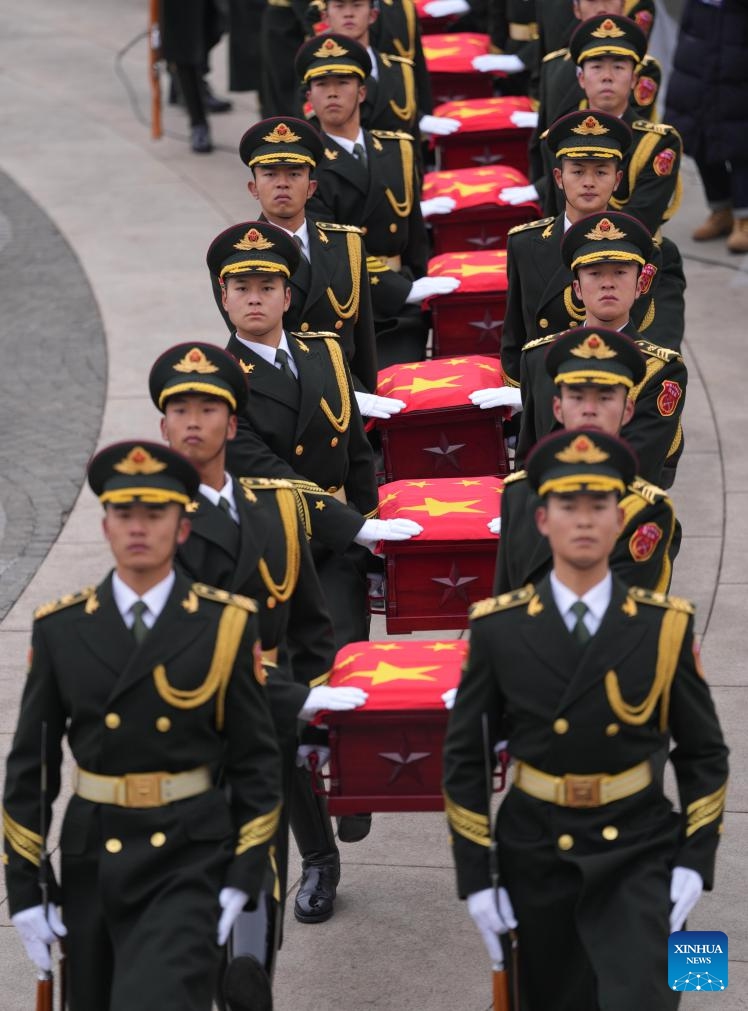 Guards of honor escort the caskets of the fallen Chinese People's Volunteers (CPV) martyrs during a burial ceremony at the CPV martyrs' cemetery in Shenyang, northeast China's Liaoning Province, Nov. 29, 2024.  (Xinhua/Li Gang)