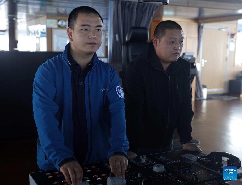 Yang Kai (L) and Geng Dong operate China's research icebreaker Xuelong 2 to break the ice, Nov. 29, 2024. Currently on China's 41st Antarctic expedition, research icebreakers Xuelong and Xuelong 2, or Snow Dragon and Snow Dragon 2, carried out icebreaking operations surrounding Zhongshan Station, a Chinese research base in Antarctica on Friday. The ships will begin unloading operations after reaching the designated anchoring position. (Xinhua/Huang Taoming)