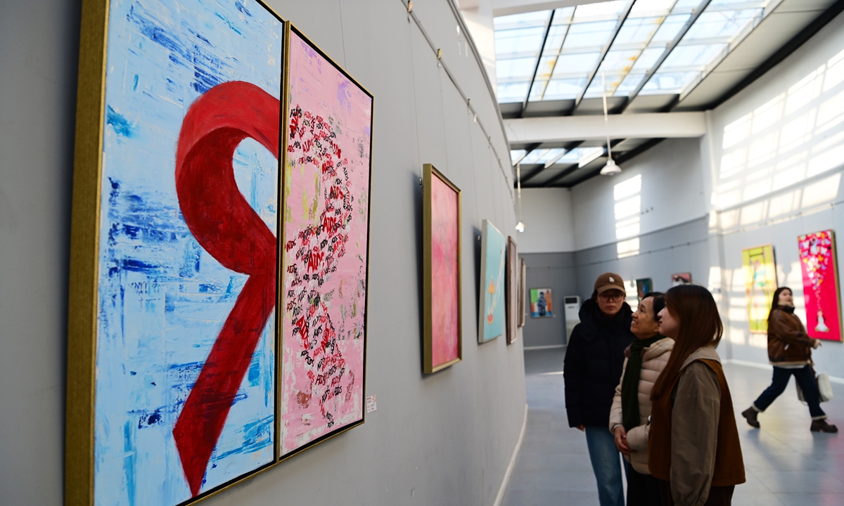 Visitors view an exhibition on promoting AIDS awareness at People's Park in Liaocheng, East China's Shandong Province, on December 1, 2024. In 1988, December 1 was designated as the World AIDS Day to raise awareness of the illness. Photo: VCG