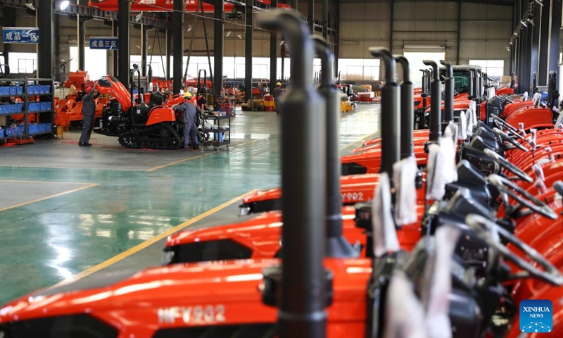 Workers adjust an assembled tractor at a local company in Chenzhou City, central China's Hunan Province, Nov. 29, 2024. In recent years, central China's Hunan Province has continuously utilized its manufacturing strengths to develop its agricultural machinery industrial chains, accelerating its transformation from traditional agriculture to modern agriculture. Photo: Xinhua