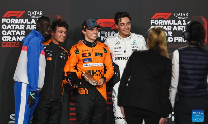 First placed McLaren's Australian driver Oscar Piastri (3rd L), second placed McLaren's British driver Lando Norris (2nd L) and third placed Mercedes driver George Russell of Britain (3rd R) pose for photos after the Sprint Race of the Qatar Grand Prix at Lusail International Circuit in Lusail, Qatar, on Nov. 30, 2024. Photo: Xinhua