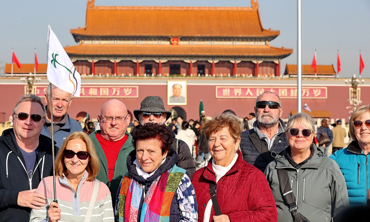 A group of foreign tourists visit Tian'anmen Square in Beijing on December 1, 2024. Data from various entry-exit stations across China indicate a significant increase in international arrivals since a visa-free policy was adopted last year. Photo: VCG