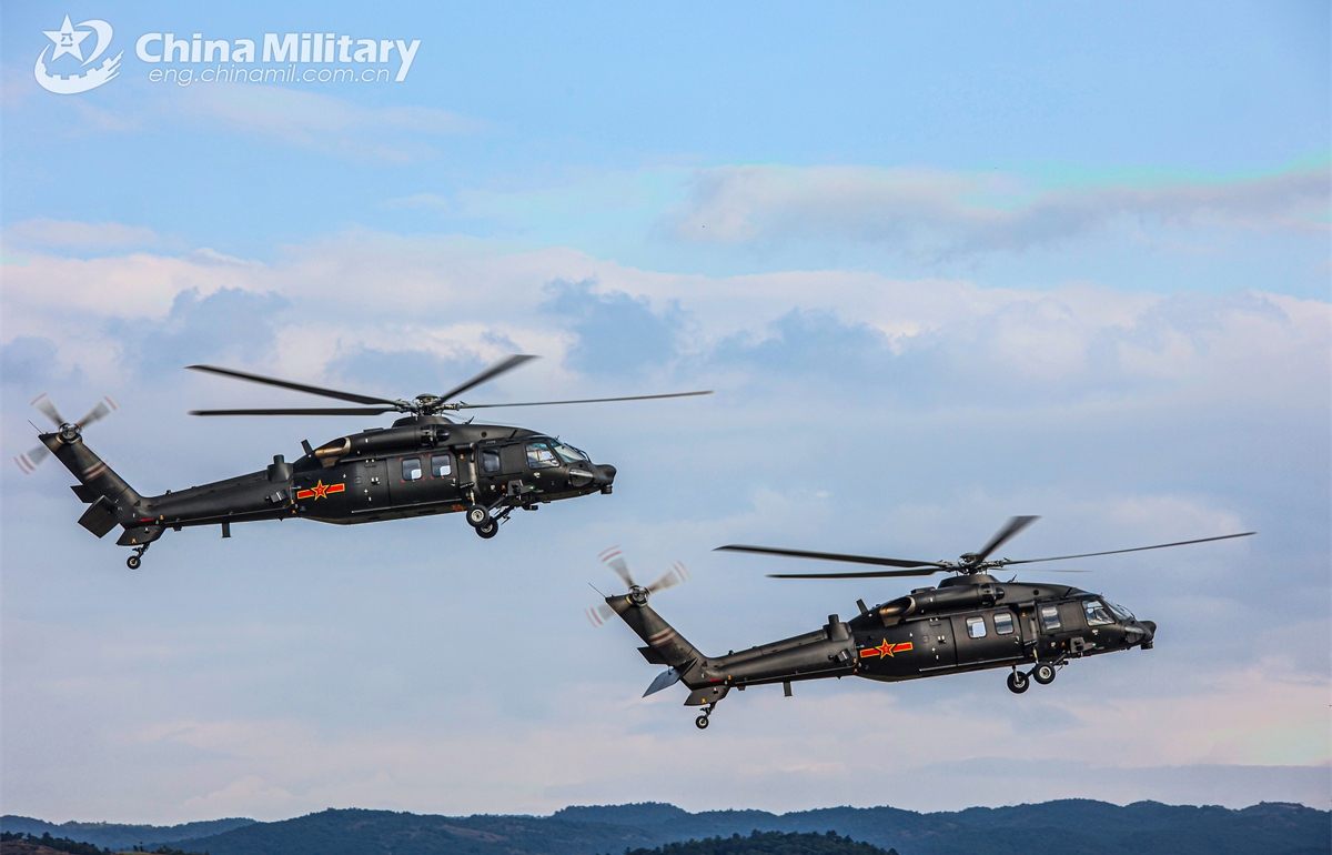 Transport helicopters attached to a brigade of the army under the Chinese PLA Southern Theatre Command fly towards designated airspace during a flight training exercise on October 23, 2024. (eng.chinamil.com.cn/Photo by Sun Changyi)