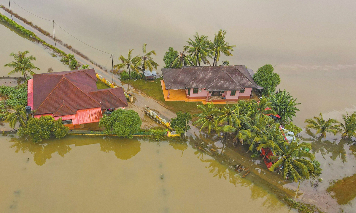 An aerial view shows two houses surrounded by floodwaters after heavy rain in Kota Bharu, Malaysia's Kelantan state on December 1, 2024. More than 150,000 people were sheltering in evacuation centers throughout Malaysia  after flooding forced them out of their homes, Arab News reported. Photo: VCG