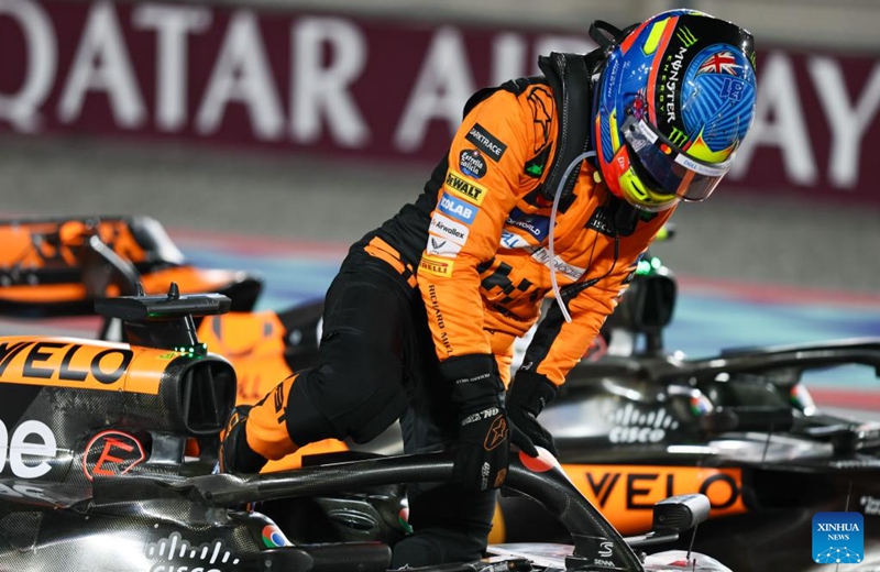 McLaren's Australian driver Oscar Piastri climbs out of the cabin after winning the Sprint Race of the Qatar Grand Prix at Lusail International Circuit in Lusail, Qatar, on Nov. 30, 2024. Photo: Xinhua