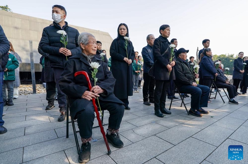 Nanjing Massacre survivors Ai Yiying, Liu Minsheng, Xia Shuqin (from L to R, front) with their families attend the family commemoration for victims of the Nanjing Massacre in Nanjing, east China's Jiangsu Province, Dec. 1, 2024. Photo: Xinhua