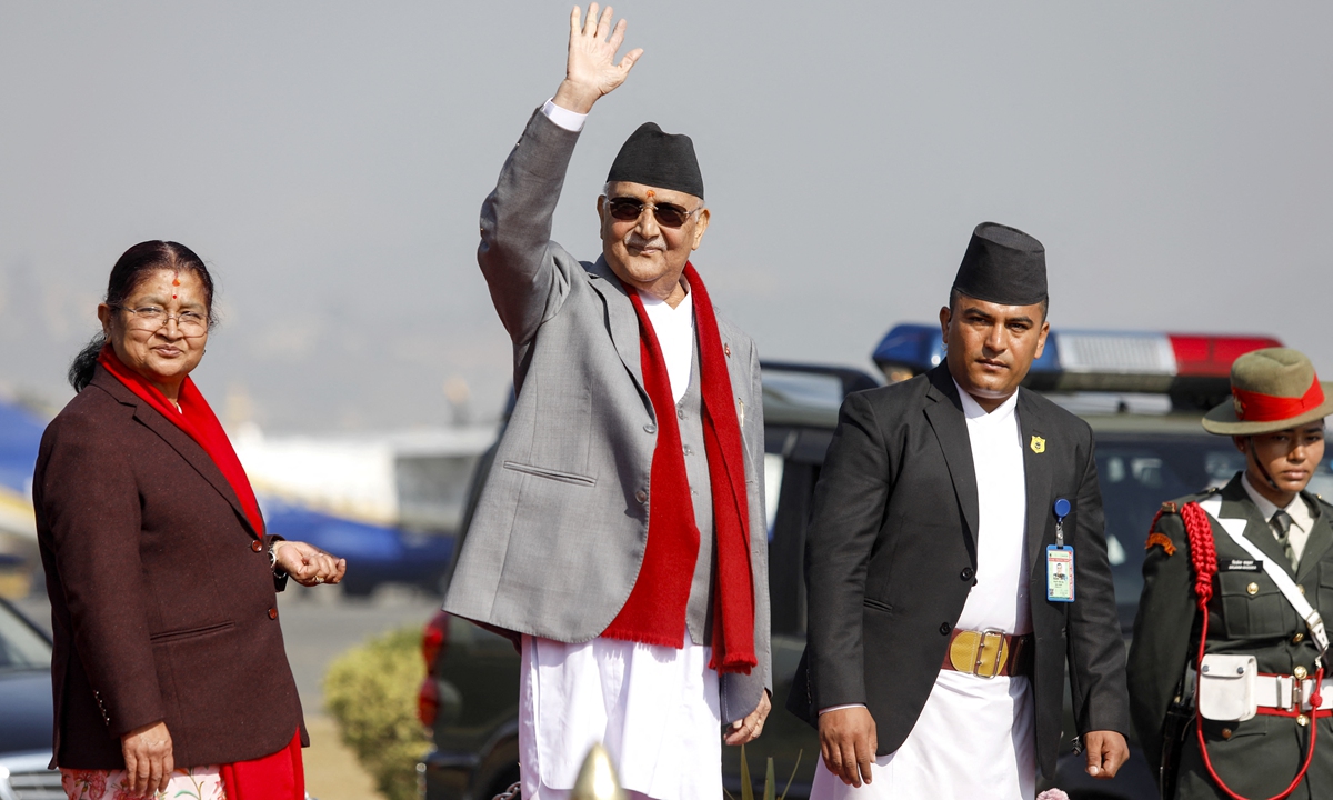 Prime Minister of Nepal KP Sharma Oli waves alongside his wife Radhika Shakya before his departure, at the Tribhuvan International airport in Kathmandu on December 2, 2024. Photo: AFP