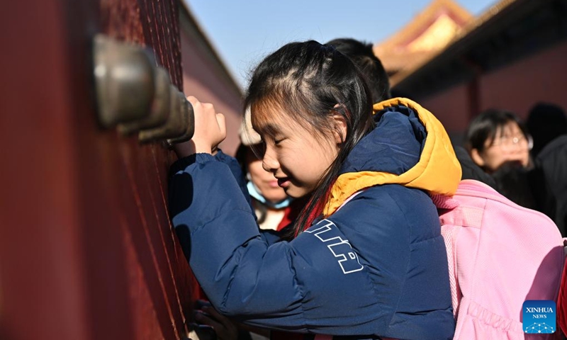 A student from the Beijing School for the Blind touches metal rivets of the door at the Palace Museum in Beijing, capital of China, Dec. 1, 2024. Sensory Experience Gallery, co-founded by Palace Museum and China Disabled Persons' Federation, was inaugurated here on Sunday, featuring creative cultural works, cultural experiences, and study tours. It integrates multi-sensory experiences to make culture more accessible for people with disabilities. Photo: Xinhua