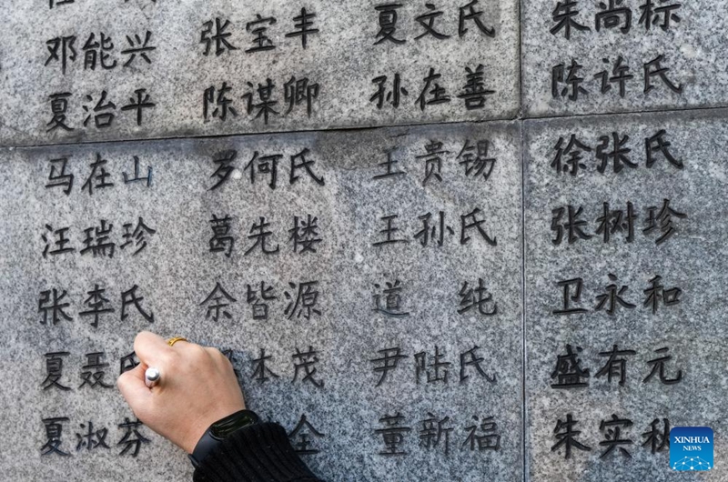 A representative uses black pens to renew the names on the wailing wall outside the Memorial Hall of the Victims in Nanjing Massacre by Japanese Invaders in Nanjing, east China's Jiangsu Province, Dec. 1, 2024. Photo: Xinhua