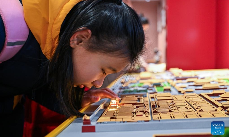 A student from the Beijing School for the Blind touches a sand table model of the Palace Museum at Sensory Experience Gallery of the Palace Museum in Beijing, capital of China, Dec. 1, 2024. Sensory Experience Gallery, co-founded by Palace Museum and China Disabled Persons' Federation, was inaugurated here on Sunday, featuring creative cultural works, cultural experiences, and study tours. It integrates multi-sensory experiences to make culture more accessible for people with disabilities. Photo: Xinhua