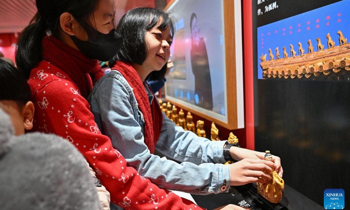 A student from the Beijing School for the Blind touches a model of a Chinese ridge beast at Sensory Experience Gallery of the Palace Museum in Beijing, capital of China, Dec. 1, 2024.  Photo: Xinhua