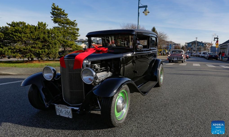 A vintage car cruises down the street during the annual Christmas Classic Car Cruise event in Richmond, British Columbia, Canada, Dec. 1, 2024. Photo: Xinhua