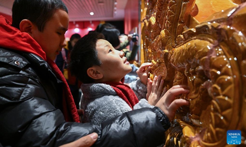 Students from the Beijing School for the Blind touch a Chiwen model, a roof ornament on ancient Chinese buildings, at Sensory Experience Gallery of the Palace Museum in Beijing, capital of China, Dec. 1, 2024. Sensory Experience Gallery, co-founded by Palace Museum and China Disabled Persons' Federation, was inaugurated here on Sunday, featuring creative cultural works, cultural experiences, and study tours. It integrates multi-sensory experiences to make culture more accessible for people with disabilities. Photo: Xinhua