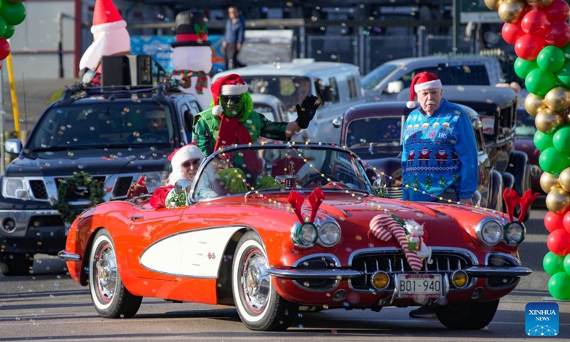 People in Christmas-themed costumes attend the annual Christmas Classic Car Cruise event in Richmond, British Columbia, Canada, Dec. 1, 2024. Photo: Xinhua