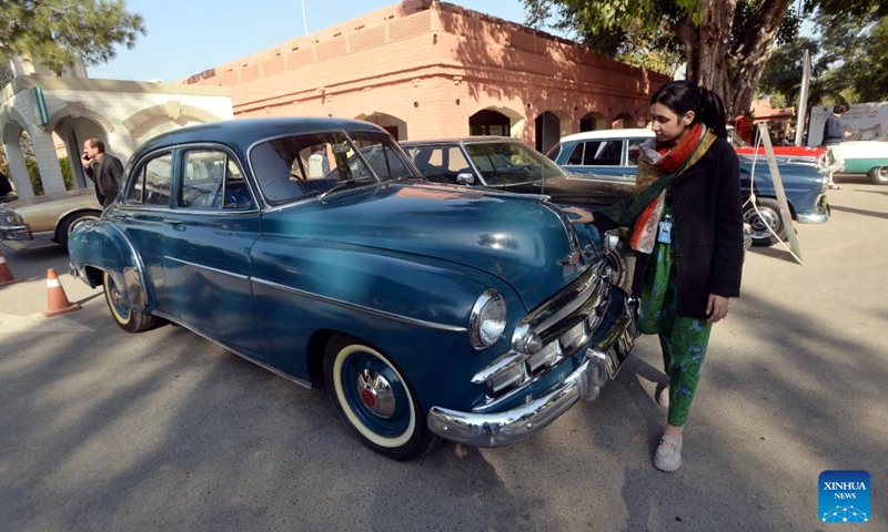 A woman visits a vintage and classic car show in Peshawar, Pakistan on Nov. 30, 2024. Photo: Xinhua