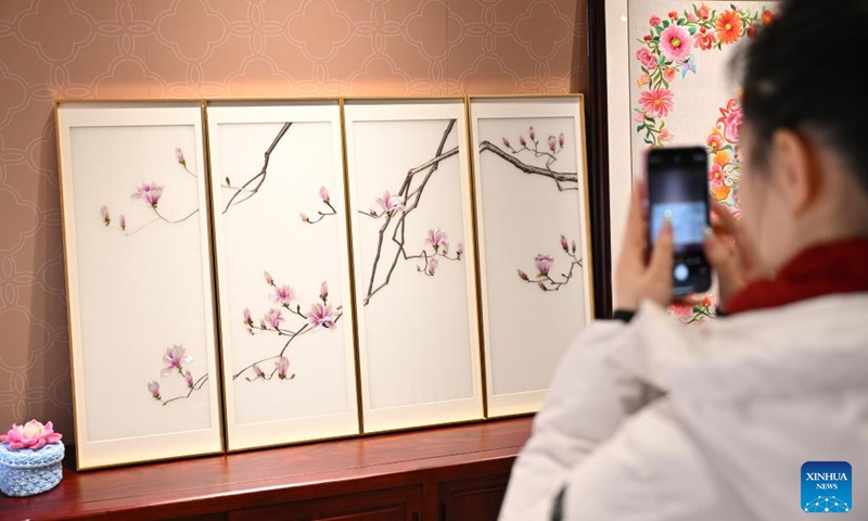 A visitor takes photos of creative cultural works made by intangible cultural heritage inheritors with disabilities at Sensory Experience Gallery of the Palace Museum in Beijing, capital of China, Dec. 1, 2024. Sensory Experience Gallery, co-founded by Palace Museum and China Disabled Persons' Federation, was inaugurated here on Sunday, featuring creative cultural works, cultural experiences, and study tours. It integrates multi-sensory experiences to make culture more accessible for people with disabilities. Photo: Xinhua