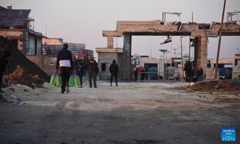 People walk near the reopened Al-Arida border crossing connecting Lebanon and Syria on Nov. 30, 2024. Israeli warplanes carried out airstrikes targeting 10 official and unofficial border crossings between Syria and Lebanon after midnight Wednesday, Syrian state media and monitoring groups reported. Photo: Xinhua