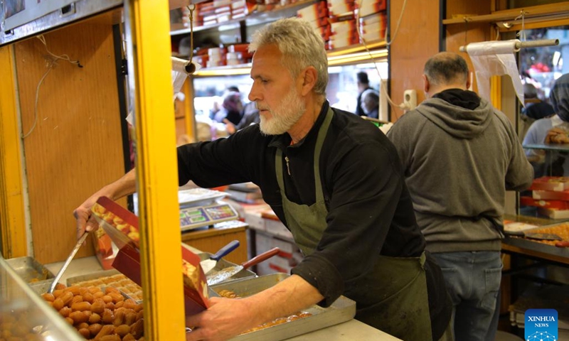 A senior works at a store in Ankara, Türkiye, on Dec. 2, 2024. Türkiye's high cost of living is pushing an increasing number of seniors back into the workforce to make ends meet, according to a leading pensioners' association. (Photo: Xinhua)