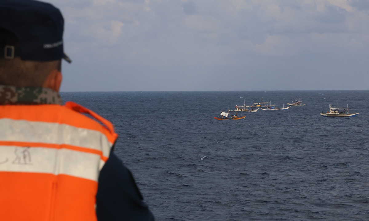 Led by a mothership apparently carrying barrels of fresh water and fuel, a group of Philippine fishing ships attempt to conduct right-infringing activities in waters around China's Houteng Jiao in the South China Sea under the pretext of fishing in November 2024. Photo: Courtesy of the China Coast Guard