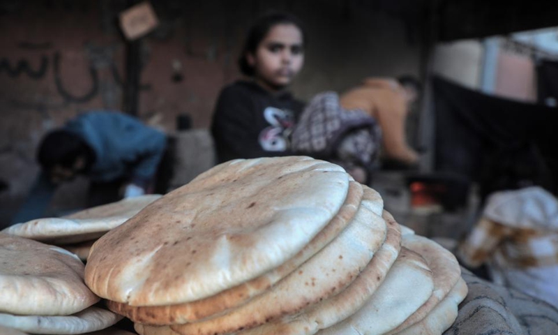 Freshly baked bread is seen at a household in the southern Gaza Strip city of Khan Younis, on Dec. 2, 2024. (Photo: Xinhua)