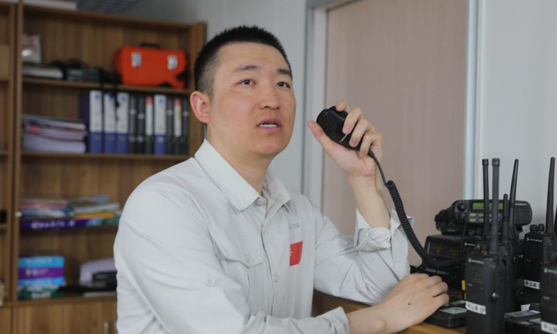 Wu Peng, an electronic engineer in charge of communication support, uses a walkie-talkie to communicate with team members at China's Zhongshan Station in Antarctica, Dec. 1, 2024. (Photo: Xinhua)