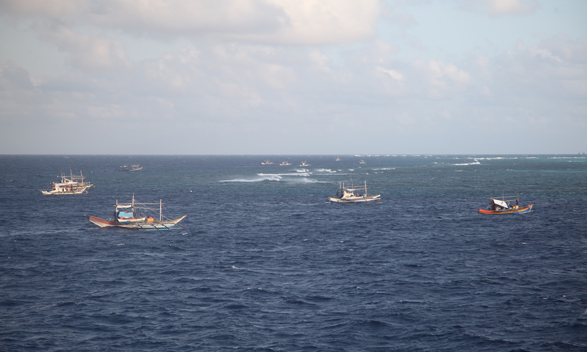 Led by a mothership apparently carrying barrels of fresh water and fuel, a group of Philippine fishing ships attempt to conduct right-infringing activities in waters around China's Houteng Jiao in the South China Sea under the pretext of fishing in November 2024. Photo: Courtesy of the China Coast Guard