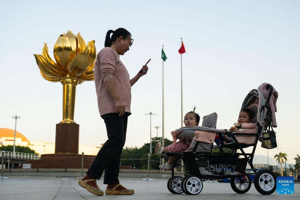 People visit the Golden Lotus Square in south China's Macao, Dec. 2, 2024. This year marks the 25th anniversary of Macao's return to the motherland. After 25 years of development, Macao has become a world renowned tourism destination, where Eastern and Western cultures have co-existed for over 400 years. (Photo: Xinhua)