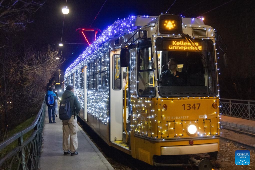 Passengers travel on a Christmas light-decorated tram in Budapest, Hungary on Dec. 2, 2024. (Photo: Xinhua)