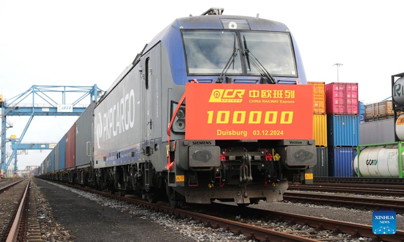 This photo taken on Dec. 3, 2024 shows the 100,000th China-Europe freight train at Duisburg Intermodal Terminal (DIT) in Duisburg, Germany. The 100,000th China-Europe freight train arrived in Duisburg, Germany on Tuesday morning, marking a historic milestone for this rail link. The train, X8083, which had departed from Chongqing, China, arrived at Duisburg's terminal at 9:10 a.m. local time, carrying electronics, industrial parts, and household appliances. The train's cargo was quickly unloaded for distribution to various destinations across Europe. (Photo: Xinhua)