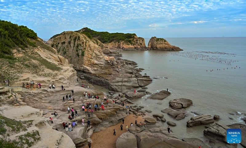 Tourists have fun on Xiawei island in Changchun Town of Xiapu County, southeast China's Fujian Province, Nov. 30, 2024. Xiapu County is blessed with sinuate seashore along with numerous tidal flats, islands and reefs. Through coordinated strategies for both ecological conservation and economic development, the county has transformed itself into a stunning hub of thriving tourism industry. Photo: Xinhua