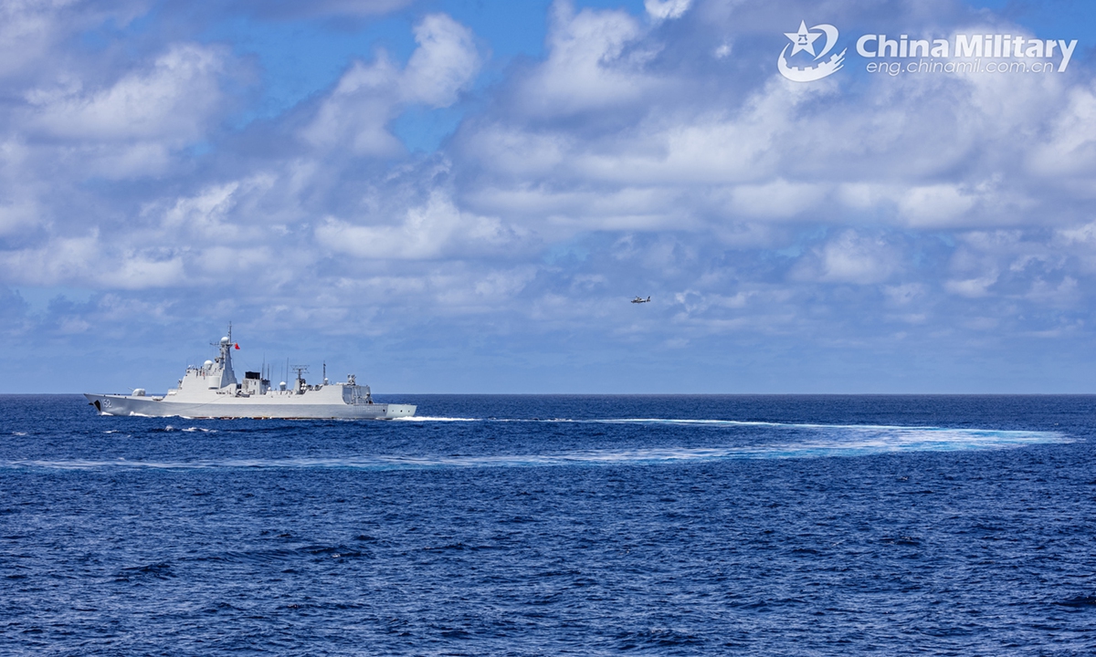 Type 052C guided-missile destroyer Jinan (Hull 152) attached to a naval fleet of the Chinese People's Liberation Army (PLA) coordinates with a helicopter during a replenishment-at-sea training exercise on November 8, 2024.  (eng.chinamil.com.cn/Photo by Wan Haichao)