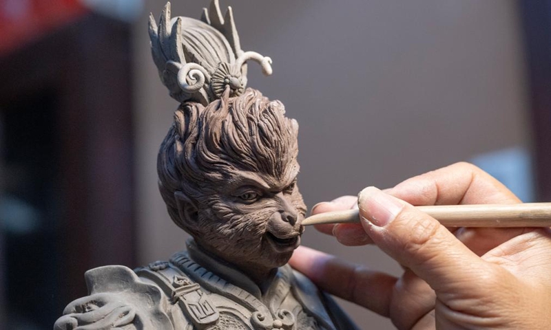 Craft artist Feng Zhiwei makes a pottery sculpture at his art studio of Meitaowan in Foshan, south China's Guangdong Province, Dec. 3, 2024. Meitaowan, literally translated as bay of beautiful ceramics, has been known for its development in ceramic arts. The municipal government established this area by transforming old factory buildings into cultural facilities and creative spaces. It is now home to studios of numerous ceramic art masters and fashion brands that aim to drive urban renewal and industrial transformation. Photo: Xinhua