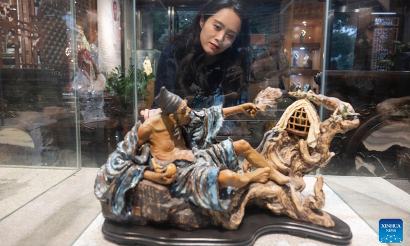 A visitor views a pottery art piece at an art museum of Meitaowan in Foshan, south China's Guangdong Province, Dec. 3, 2024. Meitaowan, literally translated as bay of beautiful ceramics, has been known for its development in ceramic arts. The municipal government established this area by transforming old factory buildings into cultural facilities and creative spaces. It is now home to studios of numerous ceramic art masters and fashion brands that aim to drive urban renewal and industrial transformation. Photo: Xinhua