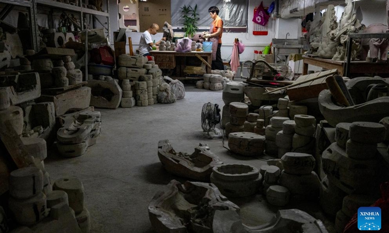 Workers assemble greenware at an art studio of Meitaowan in Foshan, south China's Guangdong Province, Dec. 3, 2024. Meitaowan, literally translated as bay of beautiful ceramics, has been known for its development in ceramic arts. The municipal government established this area by transforming old factory buildings into cultural facilities and creative spaces. It is now home to studios of numerous ceramic art masters and fashion brands that aim to drive urban renewal and industrial transformation. Photo: Xinhua