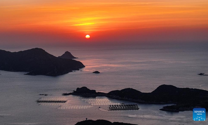 An aerial drone photo shows the sunrise scenery in Sansha Town of Xiapu County, southeast China's Fujian Province, Nov. 29, 2024. Xiapu County is blessed with sinuate seashore along with numerous tidal flats, islands and reefs. Through coordinated strategies for both ecological conservation and economic development, the county has transformed itself into a stunning hub of thriving tourism industry. Photo: Xinhua