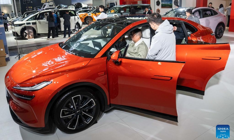 A visitor sits in a car on display at the 20th China (Changsha) International Automobile Exposition in Changsha, central China's Hunan Province, Dec. 4, 2024. The 6-day exposition, with an exhibition area of 120,000 square meters, kicked off on Wednesday at the Changsha International Convention and Exhibition Center, showcasing more than 1,000 vehicles from over 80 automobile brands. Photo: Xinhua