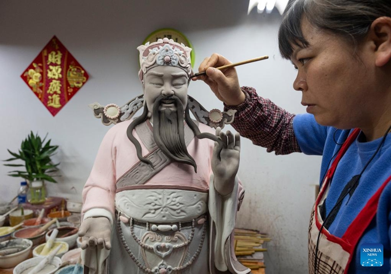 A worker glazes a ceramic piece at an art studio of Meitaowan in Foshan, south China's Guangdong Province, Dec. 3, 2024. Meitaowan, literally translated as bay of beautiful ceramics, has been known for its development in ceramic arts. The municipal government established this area by transforming old factory buildings into cultural facilities and creative spaces. It is now home to studios of numerous ceramic art masters and fashion brands that aim to drive urban renewal and industrial transformation. Photo: Xinhua