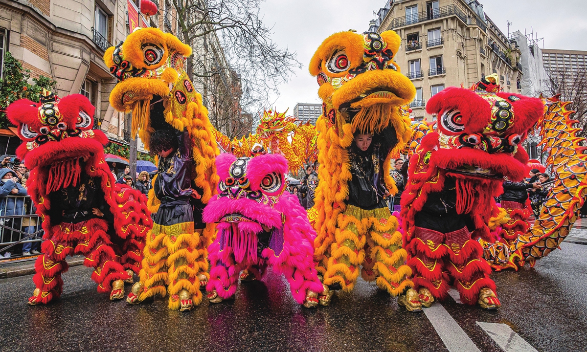 Lion dancers perform in a street of the Chinatown district of Paris, to celebrate the Chinese New Year in 2024 in Paris, France. Photo: VCG