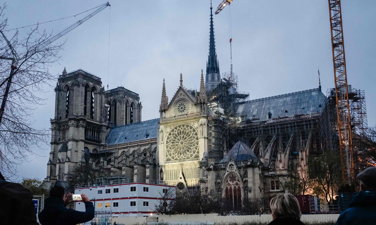 A pedestrian takes a picture of the Notre-Dame de Paris cathedral in Paris on December 4, 2024, before its reopening on December 7, 2024.  The reopening of Notre Dame will be a high-security affair, with a repeat of some measures used during the Paris Olympics, media reported. Photo: VCG