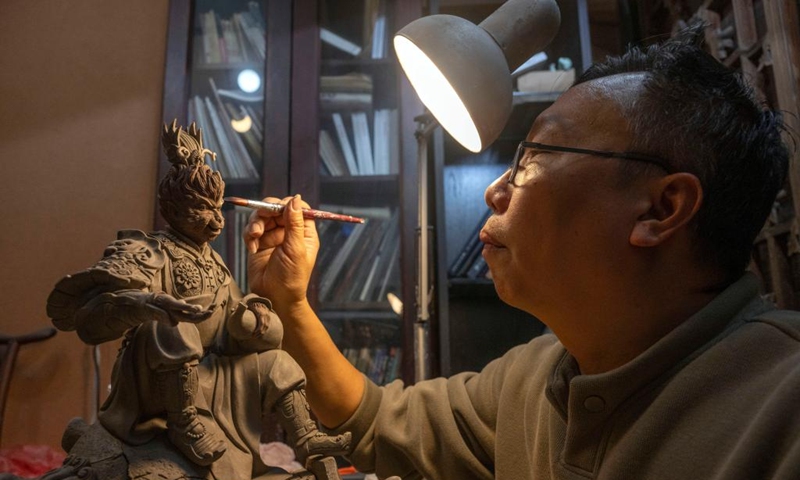 Craft artist Feng Zhiwei makes a pottery sculpture at his art studio of Meitaowan in Foshan, south China's Guangdong Province, Dec. 3, 2024. Meitaowan, literally translated as bay of beautiful ceramics, has been known for its development in ceramic arts. The municipal government established this area by transforming old factory buildings into cultural facilities and creative spaces. It is now home to studios of numerous ceramic art masters and fashion brands that aim to drive urban renewal and industrial transformation. Photo: Xinhua