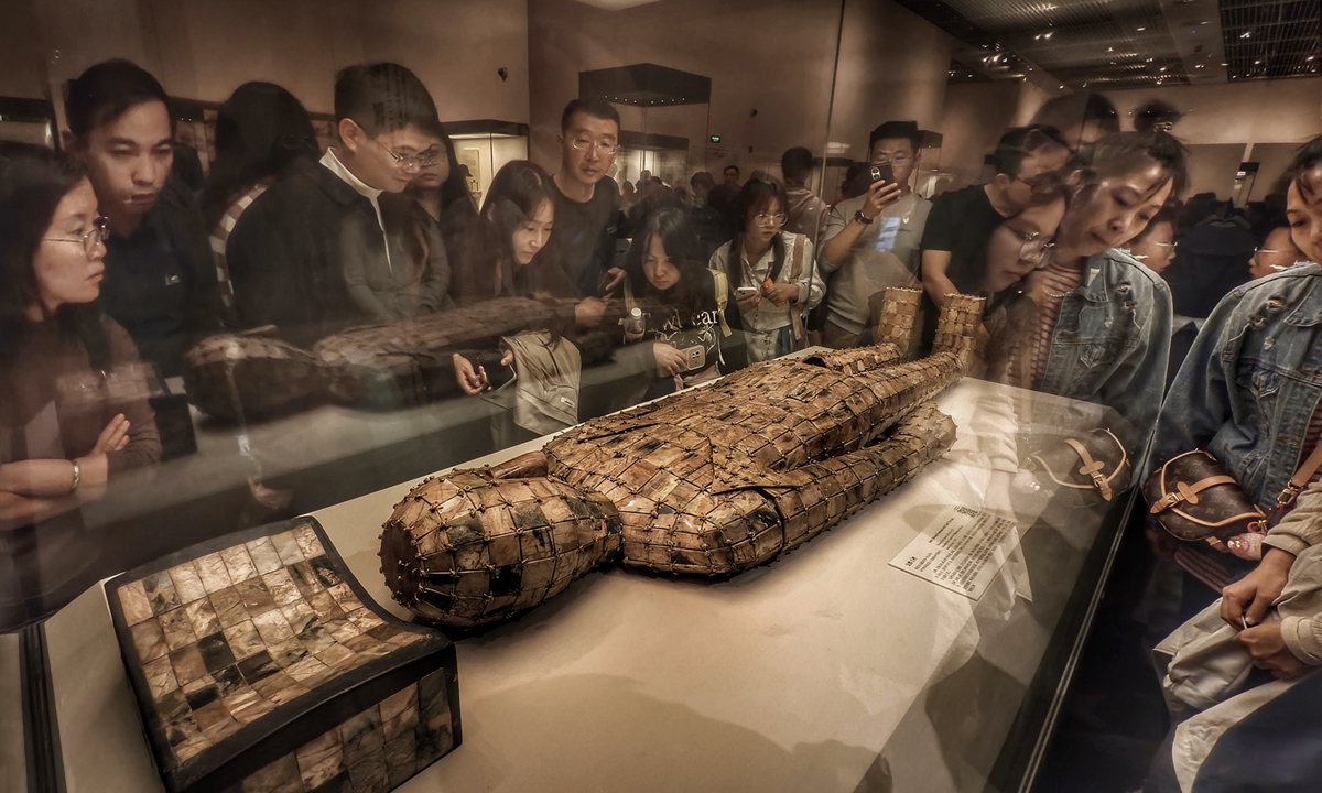 Visitors examine the jade suit sewn with gold thread at the National Museum of China. Photo: VCG