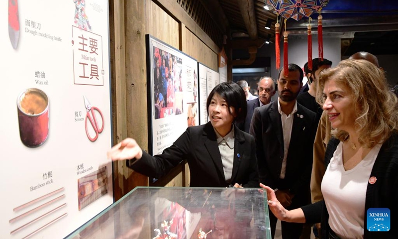 Ambassadors and diplomats from Arab States to China learns about the making techniques of decorated dough figurines, a local intangible cultural heritage, at Quanzhou intangible cultural heritage museum in Quanzhou, southeast China's Fujian Province, Dec. 1, 2024. Recently 19 ambassadors and diplomats from Arab States to China paid a visit to Fujian. Located at the eastern end of the maritime Silk Road, Fujian has given play to its unique strengths in the joint implementation of the Belt and Road Initiative (BRI) and achieved fruitful results in building the core region of the 21st Century Maritime Silk Road. Photo: Xinhua