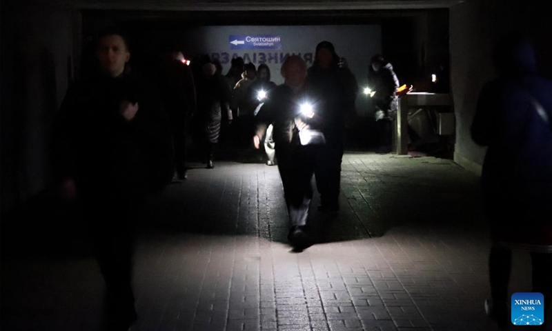 People turn on the flashlights on the phone to light the way in an underground passage in Kiev, Ukraine, Dec. 4, 2024. Photo: Xinhua