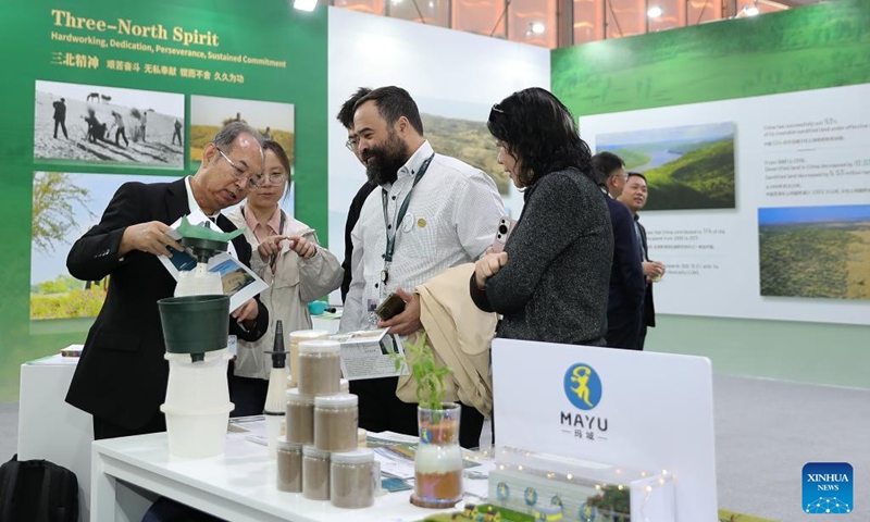 People visit the China Pavilion during the 16th Conference of the Parties (COP16) to the United Nations Convention to Combat Desertification (UNCCD) in Riyadh, Saudi Arabia, on Dec. 4, 2024. Covering more than 600 square meters, the China Pavilion is the second-largest national pavilion at the event. Its exhibition, themed Cross-Century Green Great Wall, China's Restoration in Action, showcases the nation's battle against desertification, particularly through the Three-North Shelter Forest Program, a major national initiative aimed at reversing land desertification. Photo: Xinhua