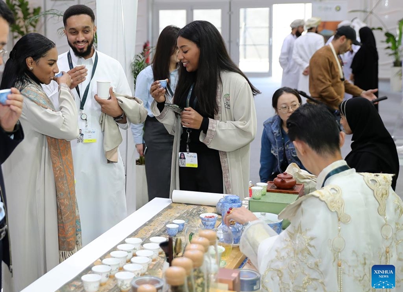 People taste Chinese tea at the China Pavilion during the 16th Conference of the Parties (COP16) to the United Nations Convention to Combat Desertification (UNCCD) in Riyadh, Saudi Arabia, on Dec. 4, 2024. Covering more than 600 square meters, the China Pavilion is the second-largest national pavilion at the event. Its exhibition, themed Cross-Century Green Great Wall, China's Restoration in Action, showcases the nation's battle against desertification, particularly through the Three-North Shelter Forest Program, a major national initiative aimed at reversing land desertification. Photo: Xinhua