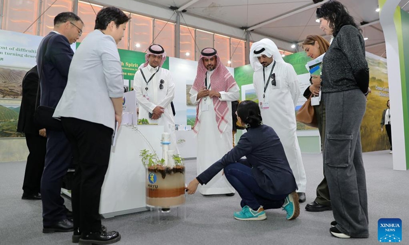 People visit the China Pavilion during the 16th Conference of the Parties (COP16) to the United Nations Convention to Combat Desertification (UNCCD) in Riyadh, Saudi Arabia, on Dec. 4, 2024. Covering more than 600 square meters, the China Pavilion is the second-largest national pavilion at the event. Its exhibition, themed Cross-Century Green Great Wall, China's Restoration in Action, showcases the nation's battle against desertification, particularly through the Three-North Shelter Forest Program, a major national initiative aimed at reversing land desertification. Photo: Xinhua