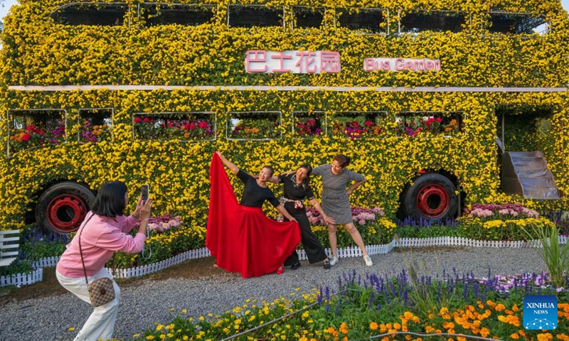 Visitors pose for photos at the 2024 Xiaolan chrysanthemum exhibition in Xiaolan Town of Zhongshan City, south China's Guangdong Province, Dec. 5, 2024. The 2024 Xiaolan chrysanthemum exhibition is held here from Nov. 29 to Dec. 18. This year's exhibition will showcase over 1,000 varieties of chrysanthemums. (Photo: Xinhua)