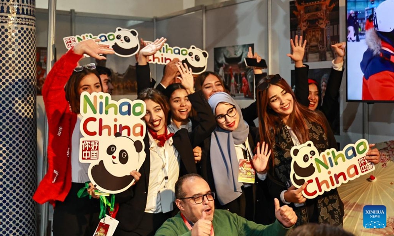 Moroccan students pose for photos with the logo of Nihao! China national tourism brand at the 6th Meknes International Tourism Forum in Meknes, Morocco, Dec. 4, 2024. (Photo: Xinhua)